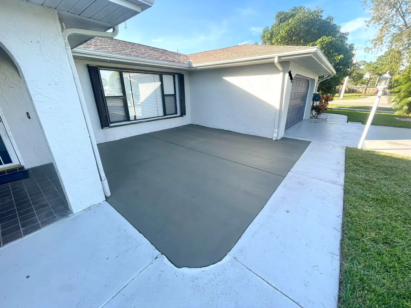 Modern grey concrete patio resurfacing home exterior